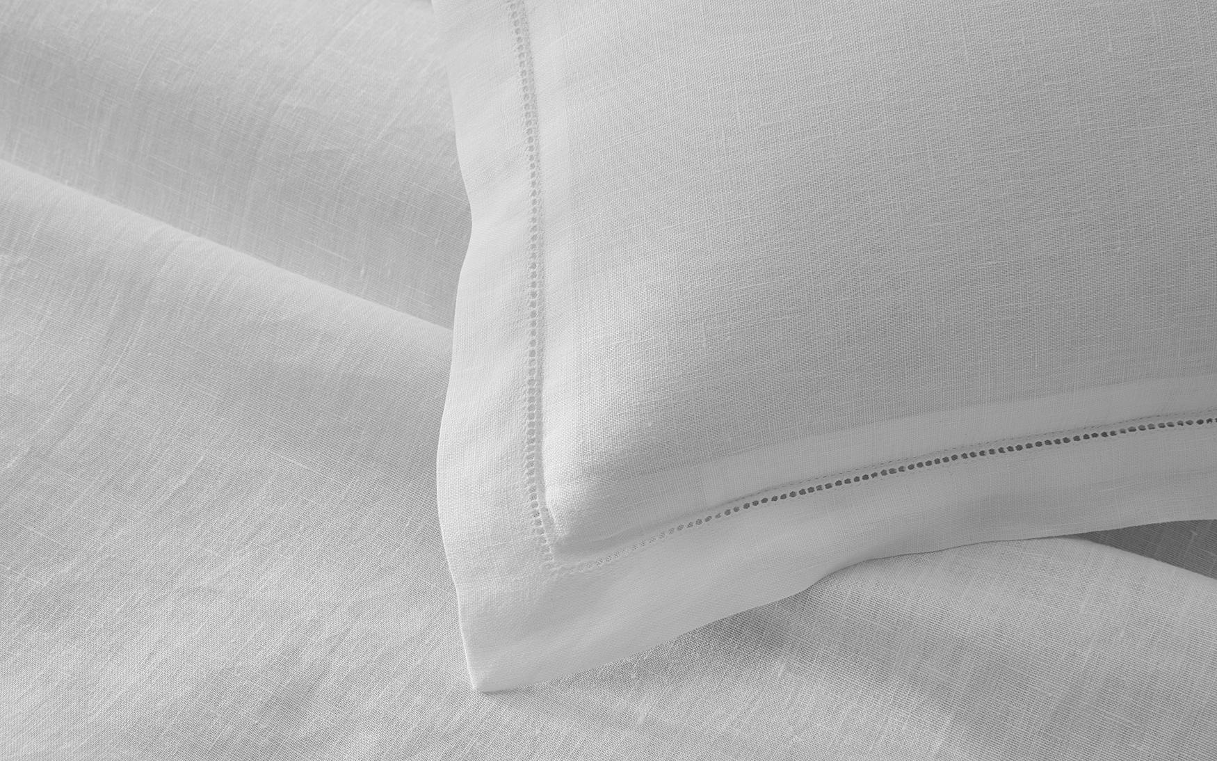 Close-up of a white pillow on the Matouk White Roman Hemstitch Bedding Collection, featuring subtle hemstitch detailing along the pillow's edge.