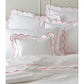 The Butterfield Bedding Collection, Azalea by Matouk features luxurious Egyptian cotton percale with white pillows and bedding, delicately scalloped and finished with pink piping for an elegant touch.
