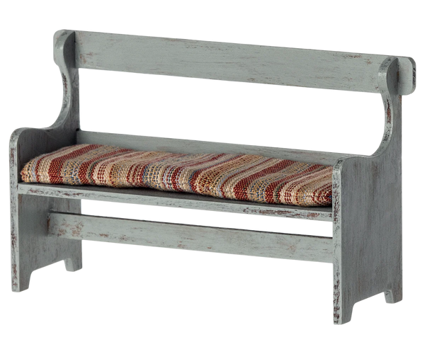 The Maileg Bench, Mouse by Maileg is a small, rustic wooden bench with a distressed finish and a cushioned seat covered in striped fabric—perfect for adding a touch of Mouse Hole Farmhouse charm to your decor.