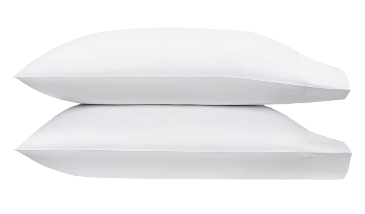 Two white pillows from the Matouk Bergamo Hemstitch Bedding Collection stacked against a white background, crafted from luxurious Egyptian cotton percale and OEKO-TEX certified for quality and comfort.