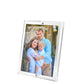 A joyful family photo is displayed in Tara Wilson Designs' Clear Beveled Frame Collection, which features a beveled lucite face for a modern touch.