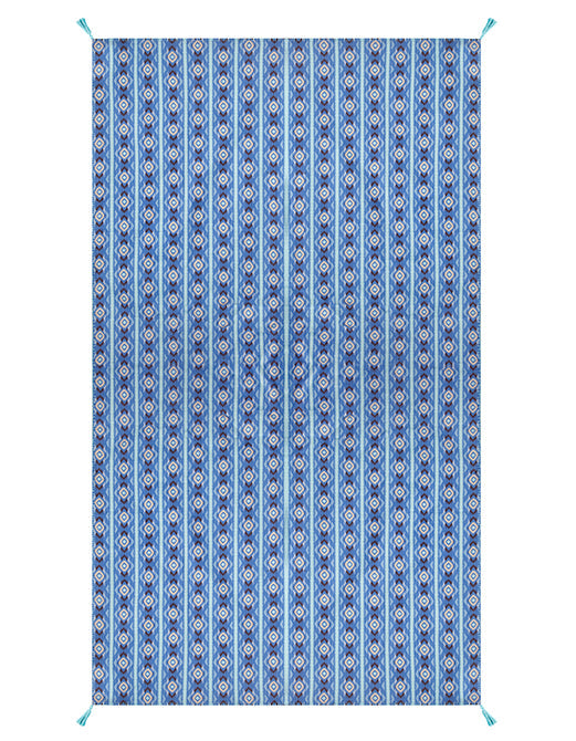 The Diamond Ikat Clearwater Table Linen Collection by Figue features a rectangular blue pattern with vertical stripes, geometric diamonds, and short blue tassels—ideal for adding flair to a vibrant tablescape.