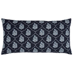 The Vinit Bolster Pillow by John Robshaw is a rectangular navy blue pillow embroidered with a repeating white floral and lattice pattern, inspired by the elegance of a Mughal garden.