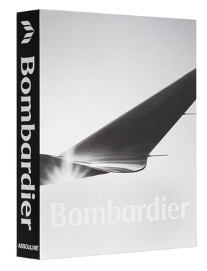 A hardcover book titled "The Impossible Collection of Bombardier" by Assouline showcases a black spine and a grayscale image of an aircraft wing on the cover, embodying the elegance of private jets and breakthroughs in business aviation.