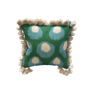 The Bukhara Blue Green Pillow by HIVE ALTERATIONS features blue and white circular patterns on a green background, accented with cream tassels—custom-made elegance displayed against a white backdrop.