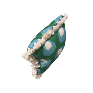 The Bukhara Blue Green Pillow by HIVE ALTERATIONS features blue and cream circular patterns with cream fringe trim—expertly crafted for those seeking unique, custom-made decorative pillows.