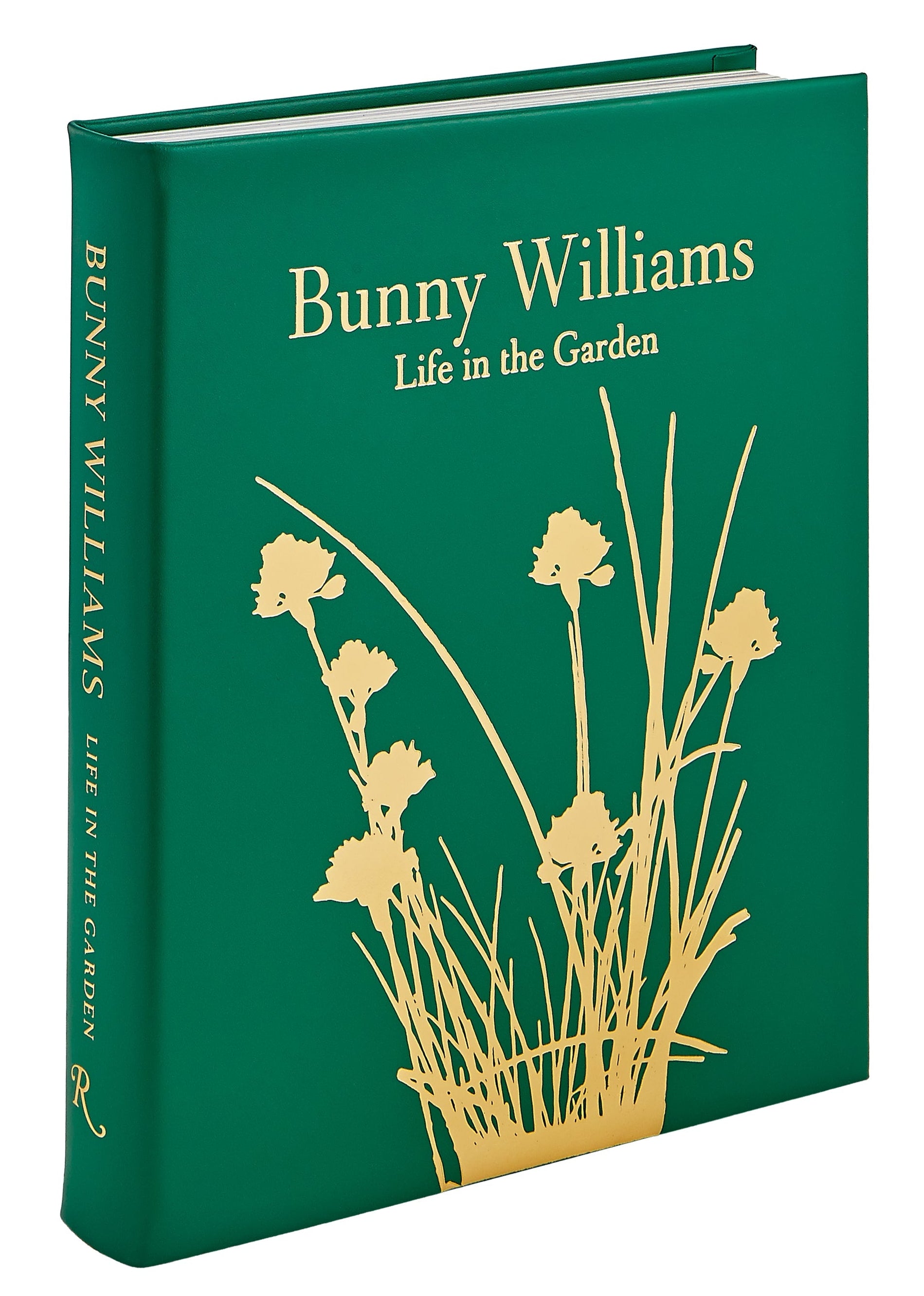 The "Bunny Williams: A Life In The Garden" leather-bound book by Graphic Image features yellow floral designs and embossed text, celebrating gardens inspired by Bunny Williams’s eighteenth-century manor.