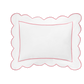 The Butterfield Bedding Collection, Azalea by Matouk, features a white rectangular Egyptian cotton percale pillow with scalloped edges and a slim red border, shown on a black background.