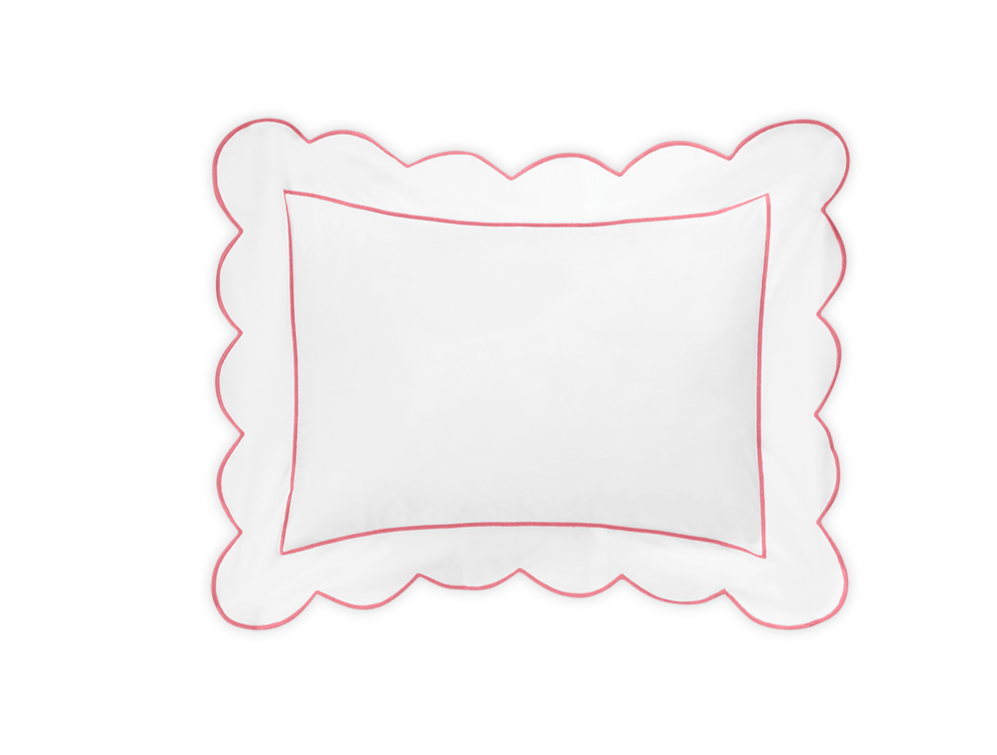 The Butterfield Bedding Collection, Azalea by Matouk, features a white rectangular Egyptian cotton percale pillow with scalloped edges and a slim red border, shown on a black background.