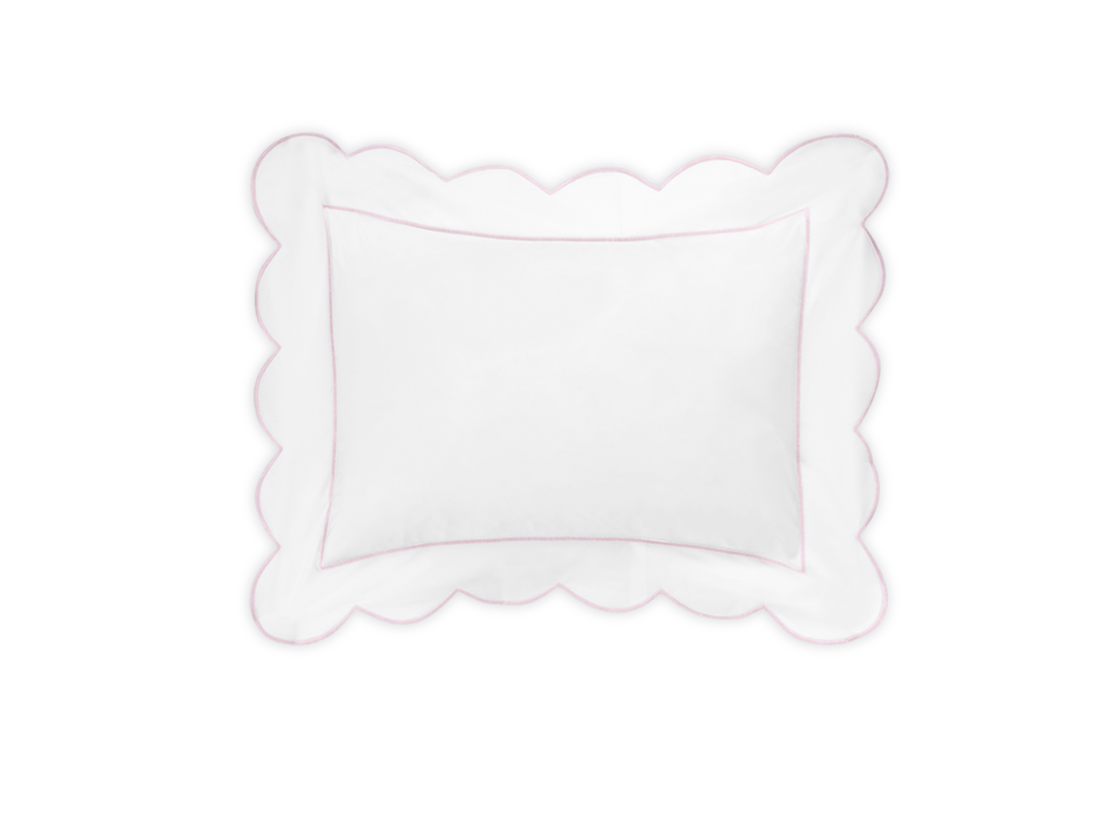 The Butterfield Bedding Collection, Pink by Matouk features a white rectangular Egyptian cotton percale pillow with scalloped edges and a subtle pink border, shown against a black background.