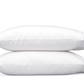 Two blue pillows from the Matouk Butterfield Bedding Collection are stacked against a plain background.