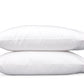 Two white pillows from the Matouk Butterfield Bedding Collection, featuring elegant scallop detailing, are stacked on top of each other against a plain white background.