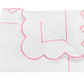 The Butterfield Bedding Collection, Azalea by Matouk features a white folded blanket with pink scallop detail and line accents, crafted from 500 thread count Egyptian cotton percale, shown on a plain white background.