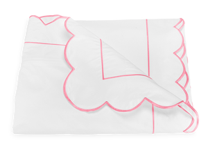 The Butterfield Bedding Collection, Azalea by Matouk is a white Egyptian cotton percale bedsheet with pink scallop edging and a pink rectangular border.