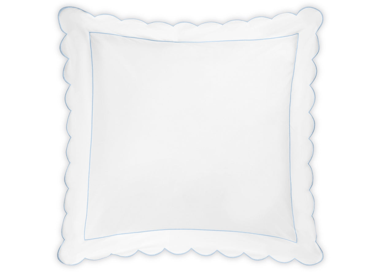 The Butterfield Bedding Collection pillow by Matouk features a white square design with scalloped edges and a delicate light blue border, evoking the elegance of luxurious Egyptian cotton sheets. It is photographed against a white background.