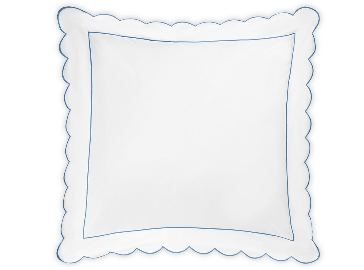 Square white pillow from the Matouk Butterfield Bedding Collection, featuring delicate scalloped edges and a fine blue border, viewed from above against a plain background. Designed to pair perfectly with Egyptian cotton sheets, this pillow showcases exquisite scallop detailing that brings an elegant touch to any bedding ensemble.