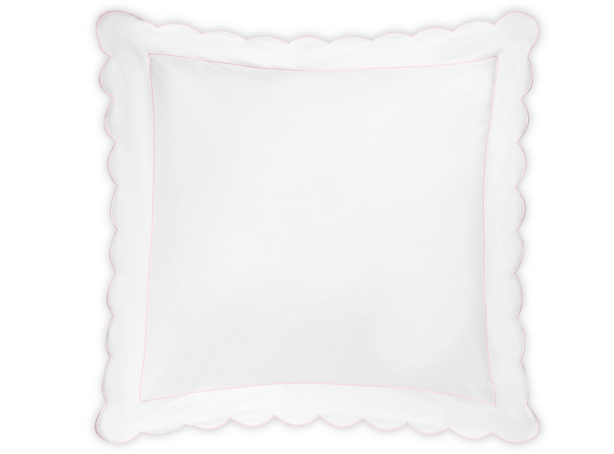 Butterfield Bedding Collection white square pillow by Matouk, featuring scalloped edges and a subtle pink border, shown against a plain white background. Designed to complement Egyptian cotton sheets and percale sheeting for an elegant, cohesive look.