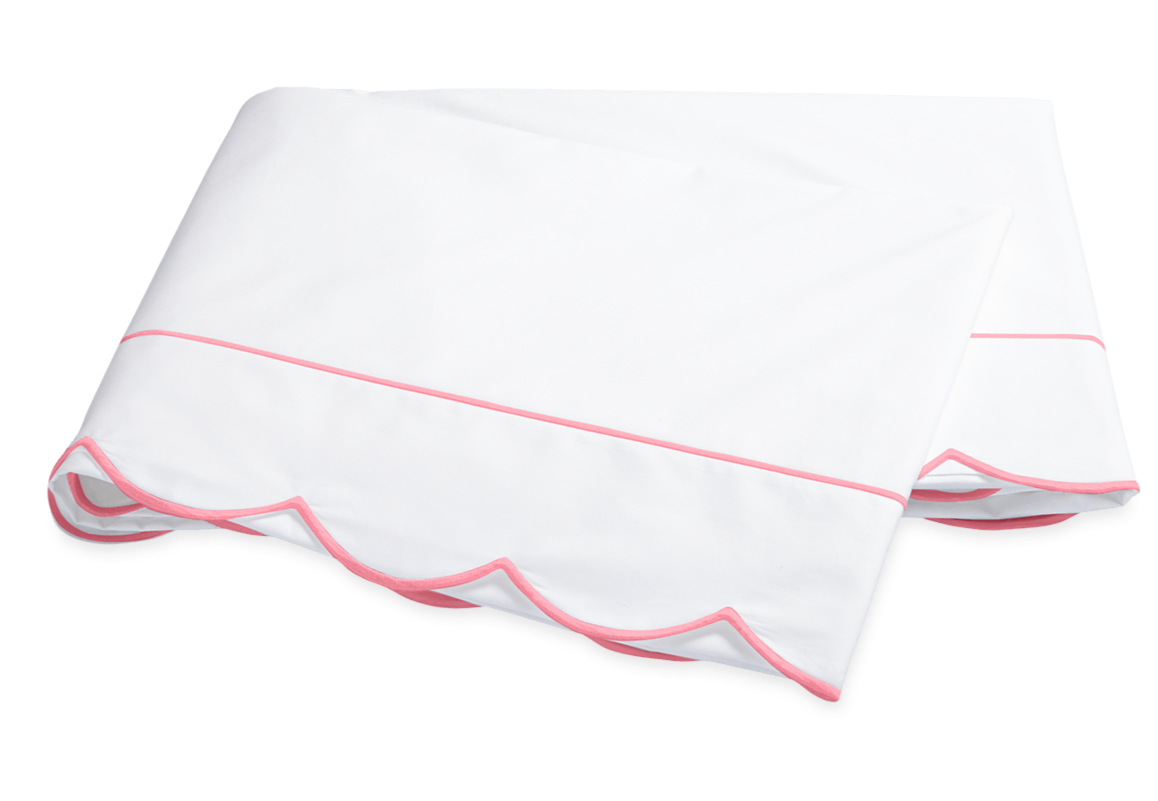 The Butterfield Bedding Collection, Azalea by Matouk features a folded white Egyptian cotton percale bedsheet with scalloped edges and a single pink line of trim.
