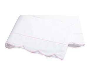 Folded white percale sheeting from the Matouk Butterfield Bedding Collection, featuring a scalloped pink trim along one edge, displayed on a plain white background.