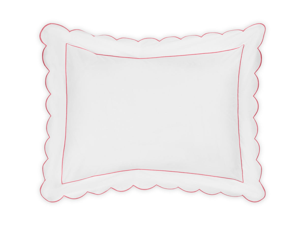 The Butterfield Bedding Collection by Matouk features a white rectangular pillow with scallop detailing along the edge and a thin pink border, designed to complement Egyptian cotton sheets; displayed on a plain white background.
