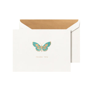 The Butterfly Engraved Thank You Card Set by Crane features a white card with a gold and blue butterfly and "THANK YOU" text, paired with an open, gold-lined envelope—ideal for sharing a heartfelt handwritten note.