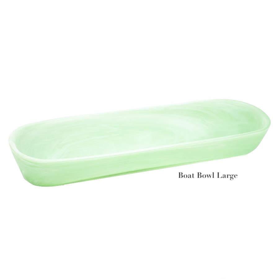 A large, light green oval bowl from the Mint Resin Serveware Collection by Nashi Home, made of shatter-resistant resin with smooth edges—ideal for stylish home decor.