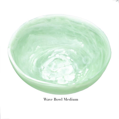 The Mint Resin Serveware Collection by Nashi Home features a medium, light green marbled bowl made from shatter-resistant resin, styled as "Wave Bowl Medium"—a chic accent for any home decor.
