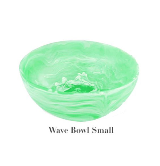 The image shows a small, round, light green bowl with a marbled wave pattern from the Mint Resin Serveware Collection by Nashi Home. Made from shatter-resistant resinware, it’s ideal for stylish home decor. Text reads "Wave Bowl Small.