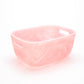A rectangular Pink Swirl Collection container by Nashi Home, featuring translucent pink color, rounded corners, and side handles—ideal as a serving piece or colorful home accent. Displayed on a white background.