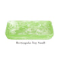 The "Mint Resin Serveware Collection" by Nashi Home features a small, rectangular, light green marbled tray made from shatter-resistant resin—a stylish addition to your decor. Labeled "Rectangular Tray Small" below the tray.