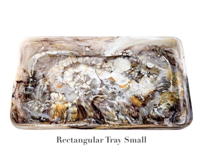 The Mocha Resin Serveware Collection by Nashi Home features a small rectangular tray with a marbled brown, gray, white, and gold pattern. This food-safe resin piece adds a touch of elegance to your decor. Text: "Rectangular Tray Small.