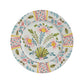 Add Amalfi Coast flair to your table with Duggan Society’s Sorrento Dinnerware Collection, featuring a white ceramic plate adorned with pink, yellow, green, and blue floral and leaf patterns plus Italian-inspired geometric borders.