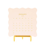 Sugar Paper 2027 Desk Calendar letterpress printed on a gold easel stand with a scalloped edge.