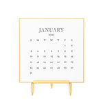 Sugar Paper 2027 Desk Calendar page, letterpress printed on extra thick card stock and displayed on a gold easel stand.