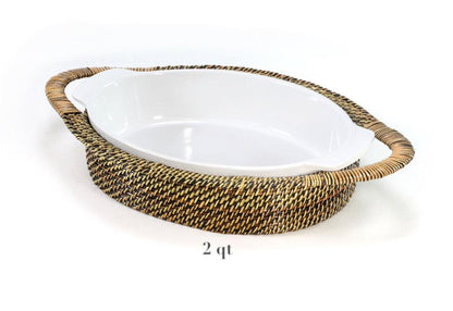 The Calaisio Oval Stoneware Roaster and Basket Collection features a white oval ceramic baking dish with woven wicker holder and side handles, labeled "2 qt" for its two-quart capacity.