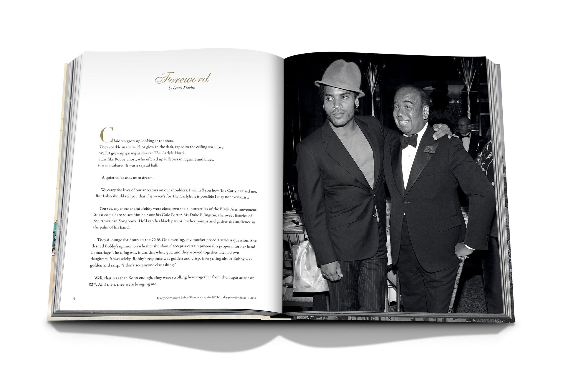 Open book showing a photograph of two men standing together, one in a hat and the other in a suit. The left page features a foreword text by Quincy Jones. The image exudes an air of luxury, reminiscent of old New York City charm, perhaps taken at "The Carlyle" by Assouline.