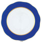 The Herend Silk Ribbons Charger is a round handmade porcelain plate, white with a cobalt blue scalloped rim and gold trim, shown from above.
