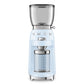 A light blue SMEG Coffee Grinder from Smeg's retro-style collection features a transparent hopper and a glass container for the perfect grind every time.