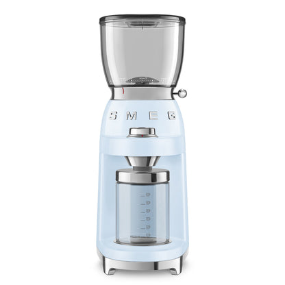 The Smeg Coffee Grinder Collection in light blue features a transparent bean hopper, glass container for ground coffee, and adjustable grinding levels—ideal for use with espresso machines.