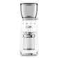 The SMEG Coffee Grinder Collection by Smeg features premium grinding with a clear bean hopper and grind container, showcasing a retro design and labeled settings for the perfect grind every time.