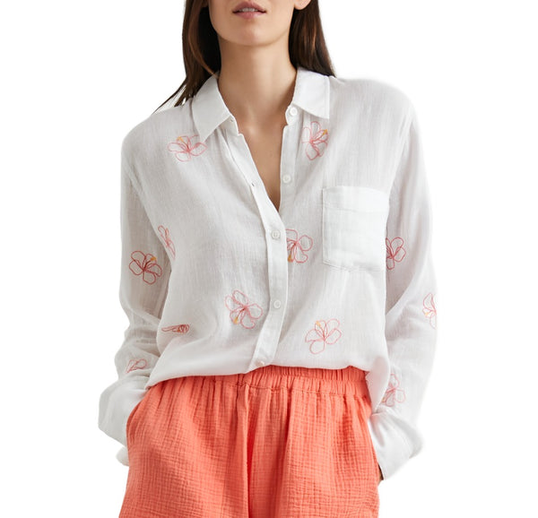 Woman in a Rails Charli Shirt with red floral embroidered pattern, paired with a coral pleated skirt, cropped at the torso.