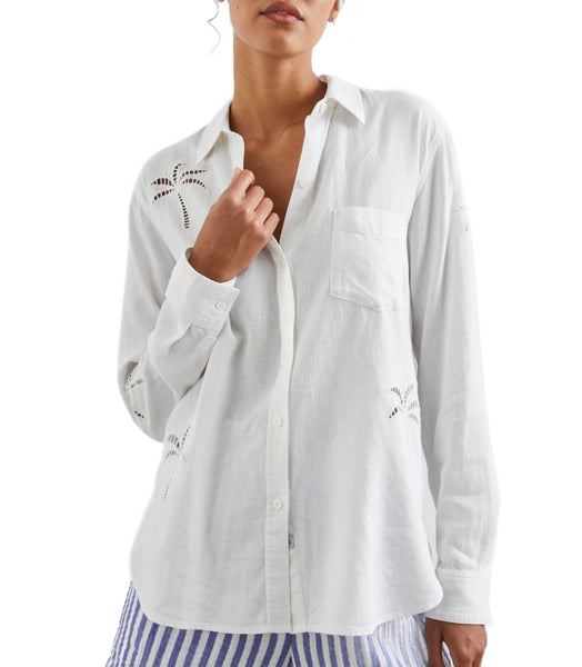 Woman in a Rails Charli Eyelet Shirt with palm tree eyelet embroidery, touching her collar, against a white background.