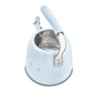 The SMEG Whistling Kettle Collection by Smeg features an induction-compatible, light blue, open-top kettle with a metallic interior and an ergonomic handle for comfort, combining form and function effortlessly when viewed from above.