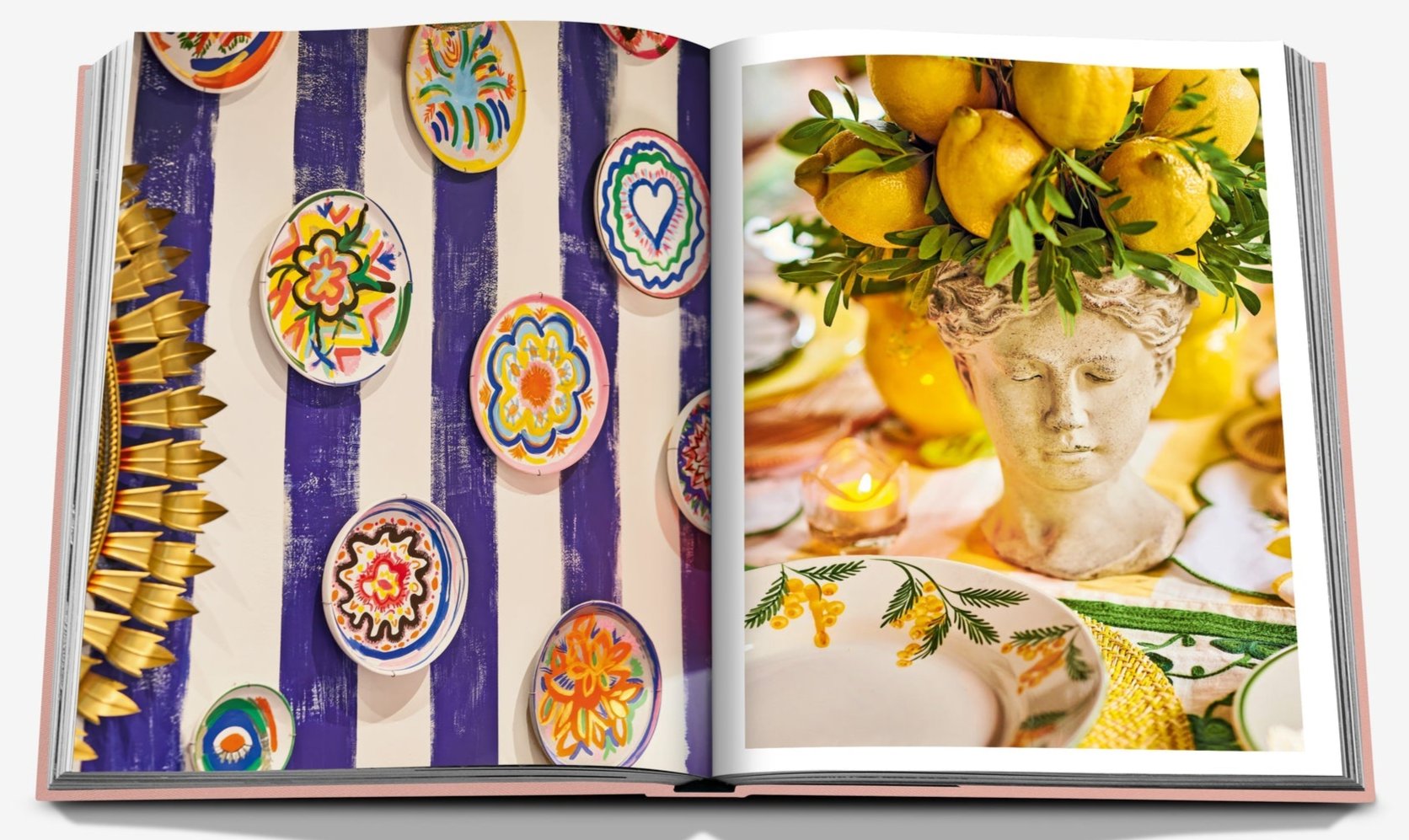 The Assouline book "Marbella Sol" features colorful ceramic plates evoking Marbella's charm on the left page, while a decorative lemon centerpiece alongside a classical bust brings to life a European Miami vibe on the right.