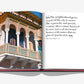 The open book "Santo Domingo" by Assouline features a vibrant facade from the Zona Colonial on the left and a thought-provoking quote by Mario Vico Magistretti about urban growth on the right.