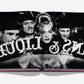 A black-and-white photo of four people peering through a window in "Paris by Paris" by Assouline evokes Parisian charm and hints at the Belle Époque's artistic flair and cultural revolutions, with the reversed text "BAR & LUGI.