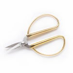 The Mini Gold Scissors by Haute Papier feature gold handles and short, sharp stainless steel blades, displayed on a white background.