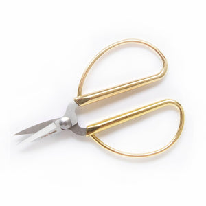 The Mini Gold Scissors by Haute Papier feature gold handles and short, sharp stainless steel blades, displayed on a white background.