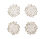 Four circular, beaded Winter Lace Coasters featuring a white and silver snowflake pattern.