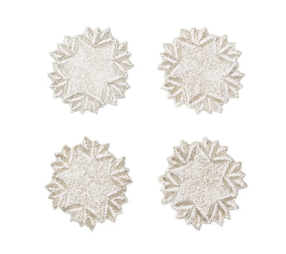 Four circular, beaded Winter Lace Coasters featuring a white and silver snowflake pattern.